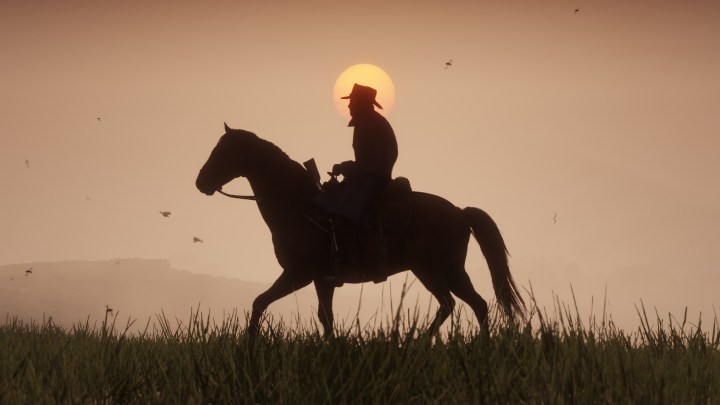 A silhouette of a cowboy riding a horse in Red Dead Redemption 2.