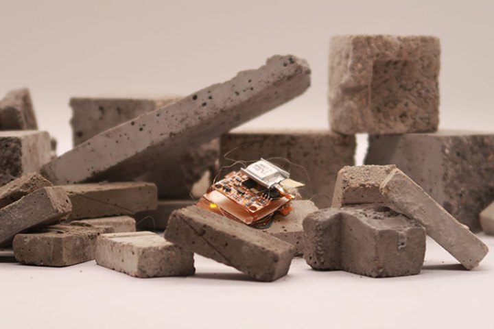 A tiny insect-sized robot is maneuvering over uneven blocks of stone. 