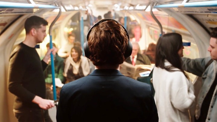 Man wearing Sony WH-1000XM4 ANC Headphones on public transportation.