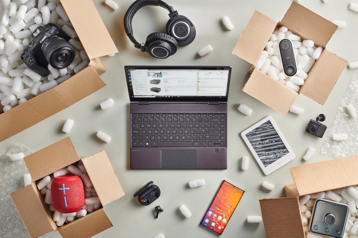 Amazon is surrounded by boxes of laptop tech gear.