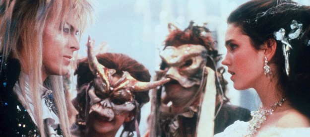 David Bowie, Jennifer Connelly, and two masked characters in Labyrinth.