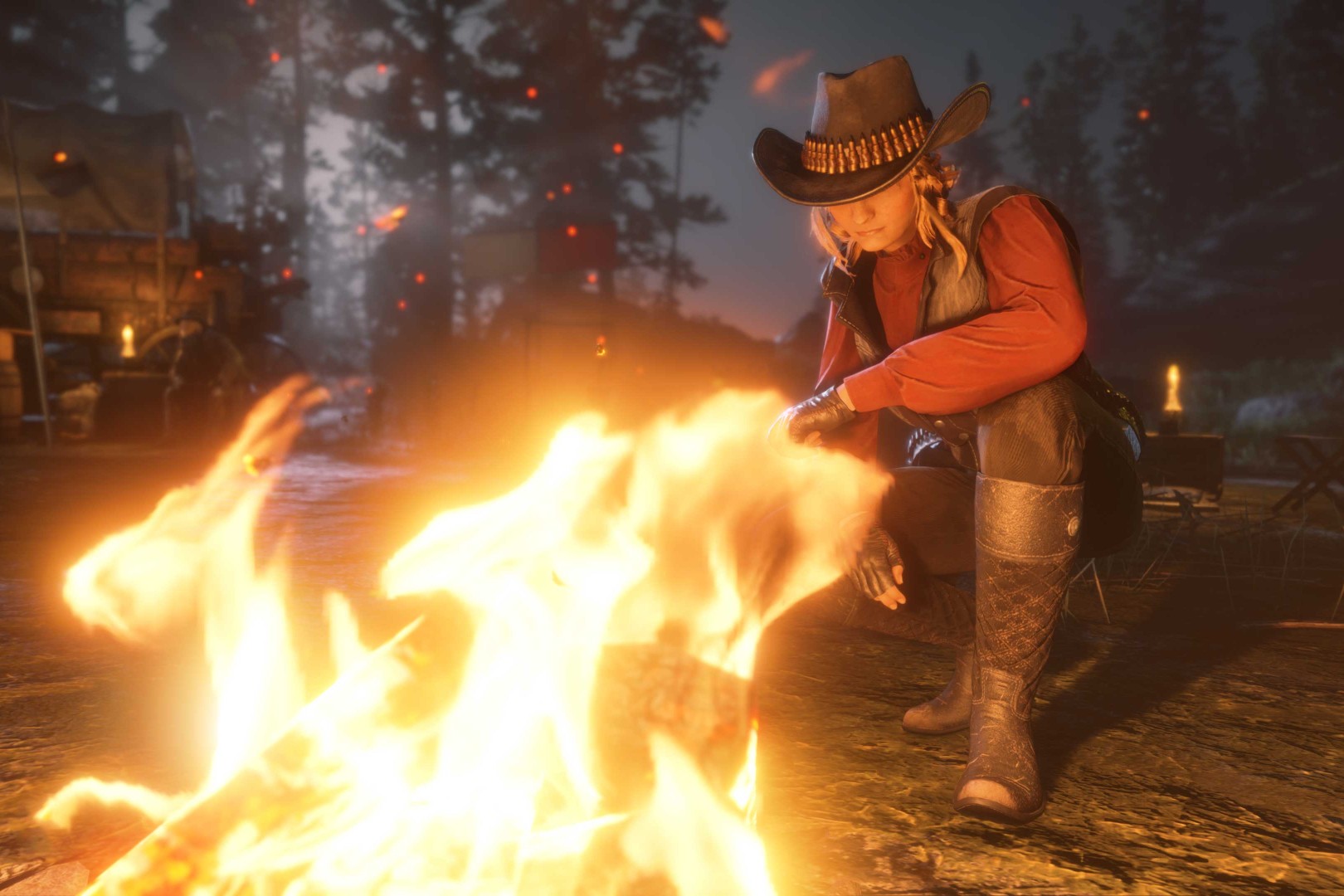A cowboy sitting by a fire.