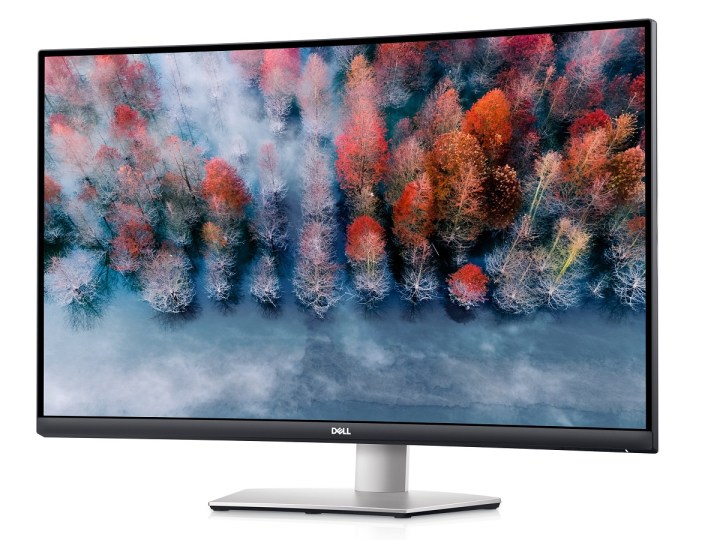 The 32-inch Dell S3221QS curved 4K monitor with a forest scene on the screen.