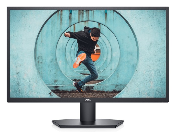 A 27-inch Dell monitor with a man in a dynamic pose on the screen.