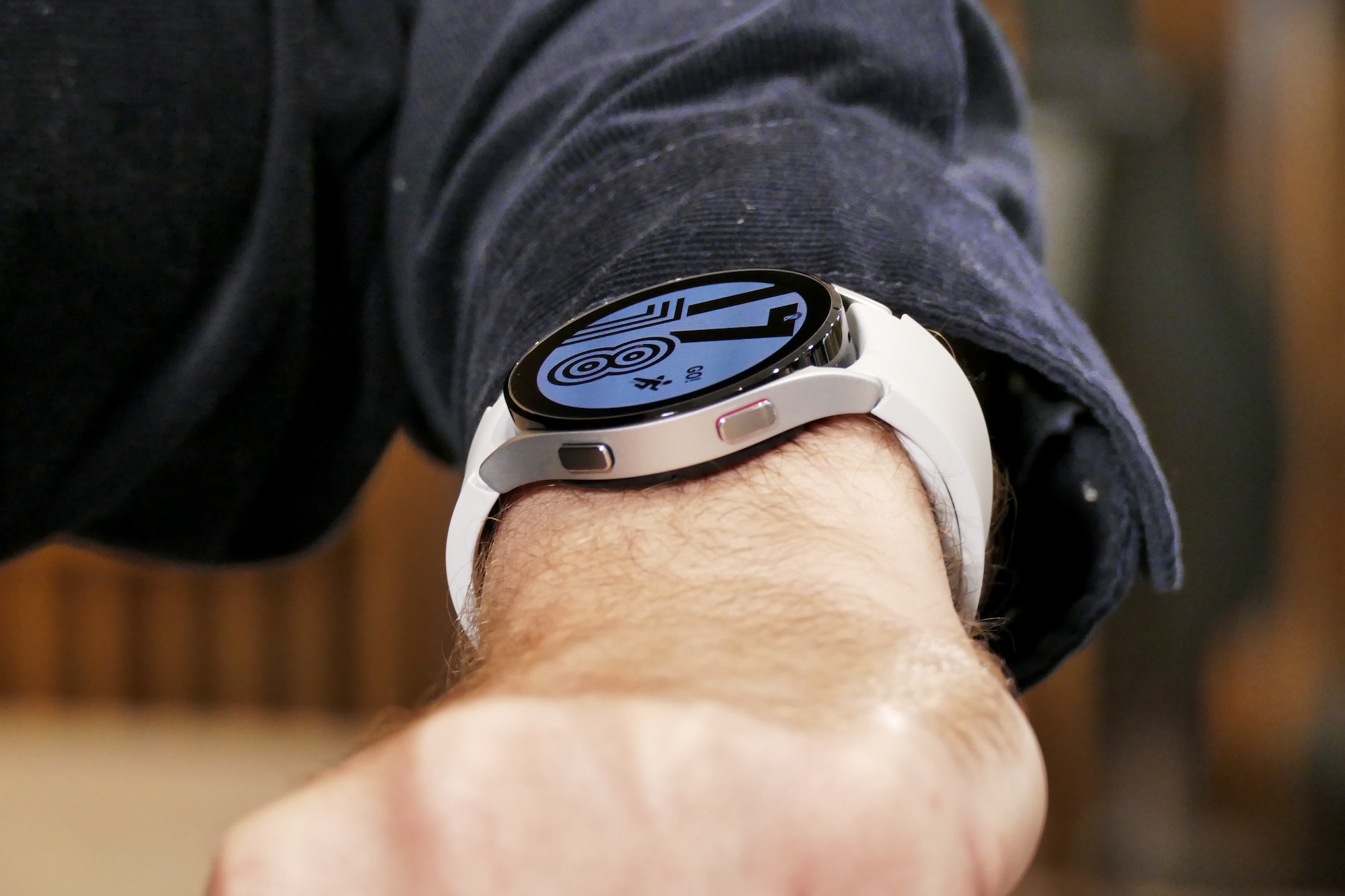 Galaxy Watch 4 on the wrist, showing side buttons.