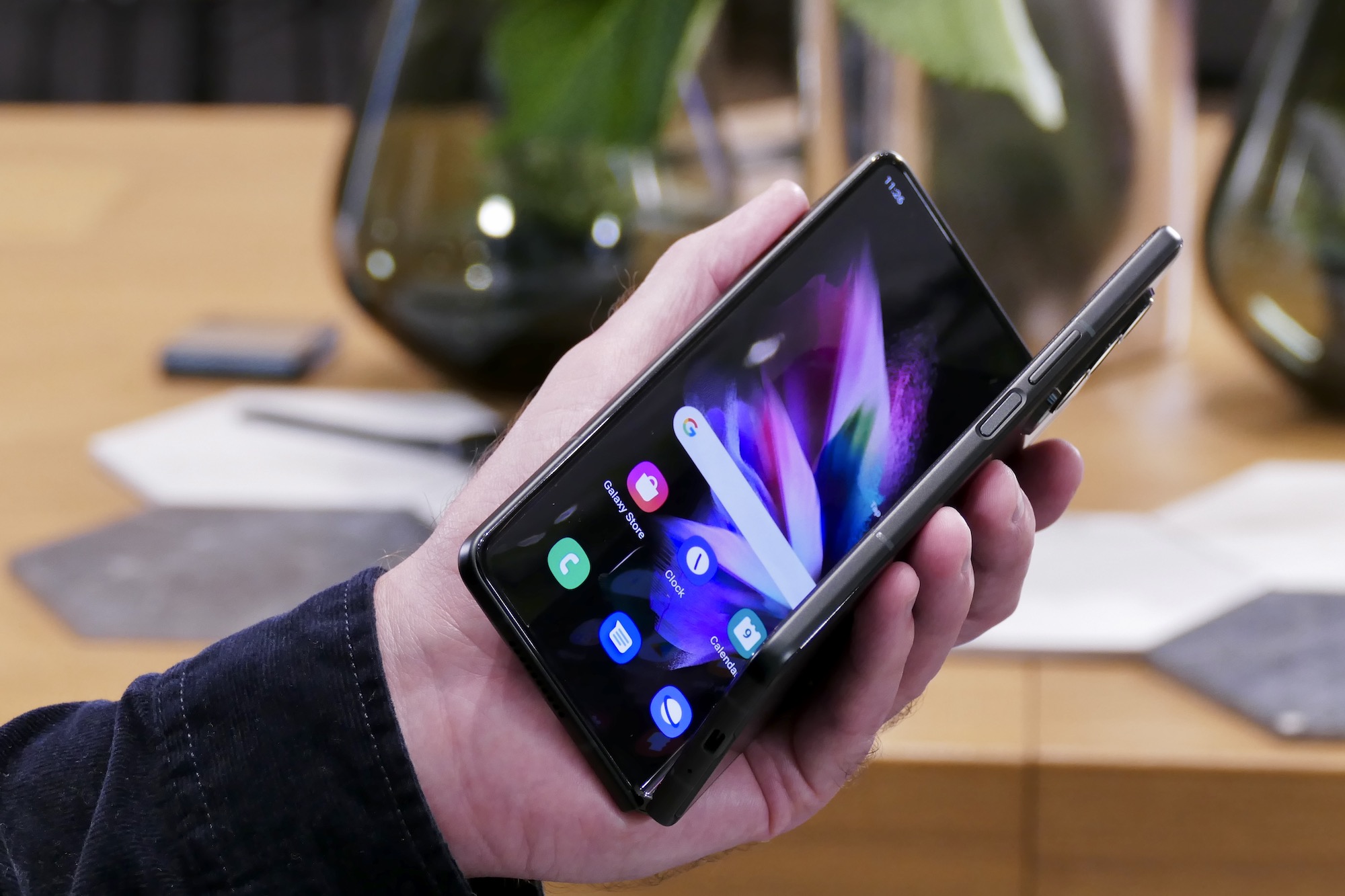 Galaxy Z Fold 3 almost closed in hand.