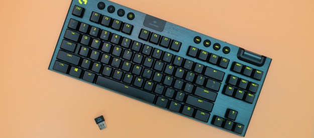Logitech G915 TKL keyboard on an orange background.