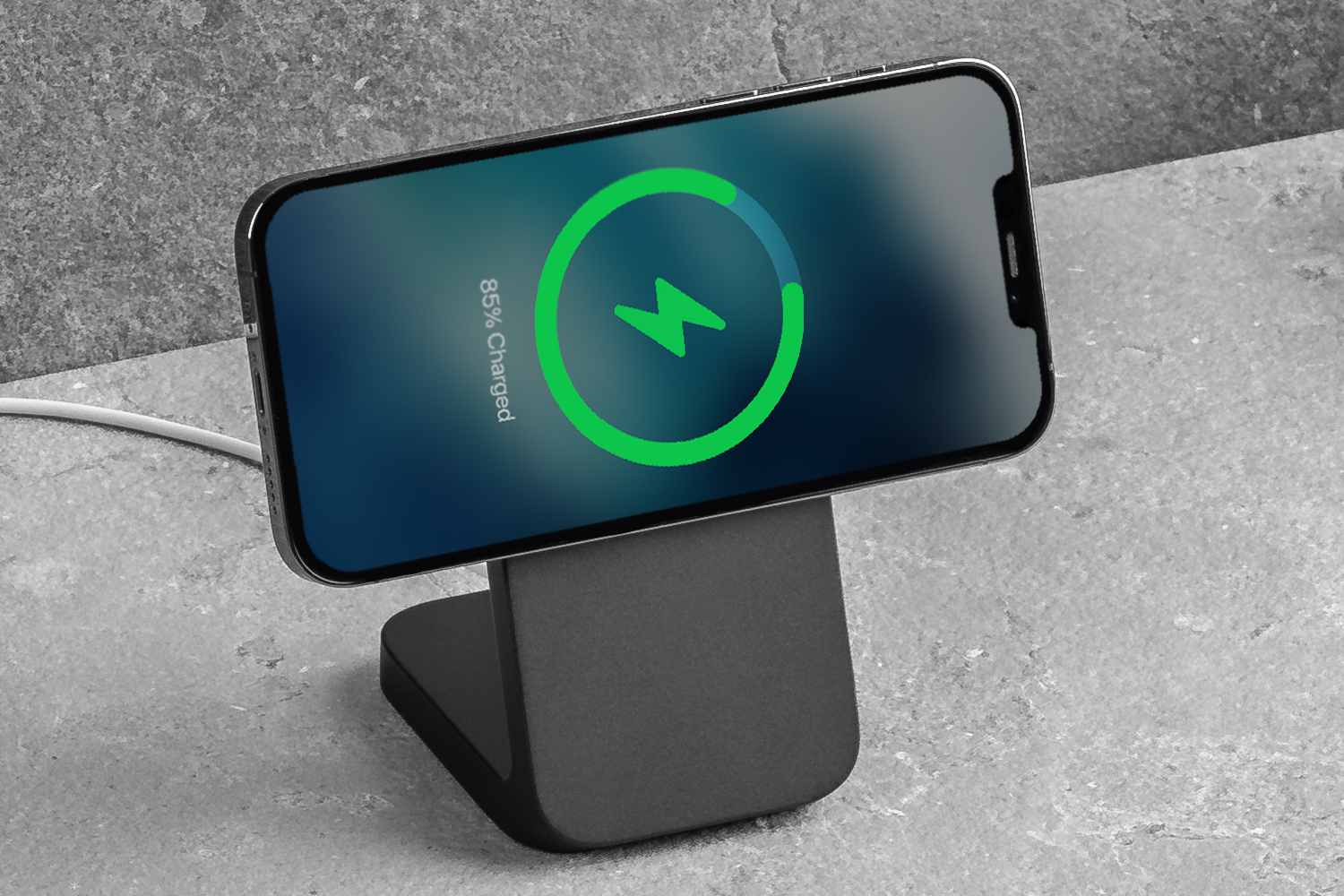 Nomad MagSafe Mount Stand with iPhone charging in landscape orientation.