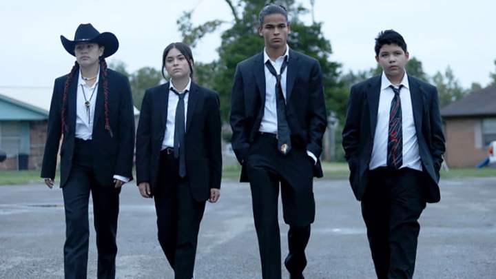 Four kids from Reservation Dogs, walking in suits.