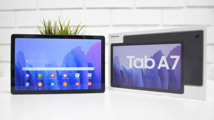 samsung galaxy tab a7 tablet with home screen open on a white brick wall background
