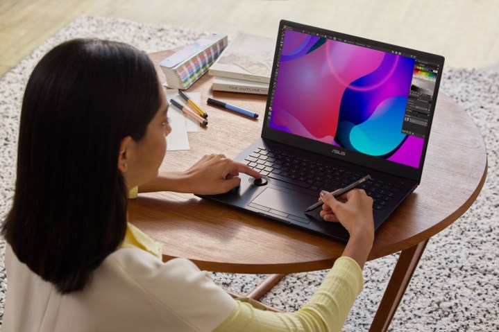 Woman using the Asus ProArt Studiobook on a desk.