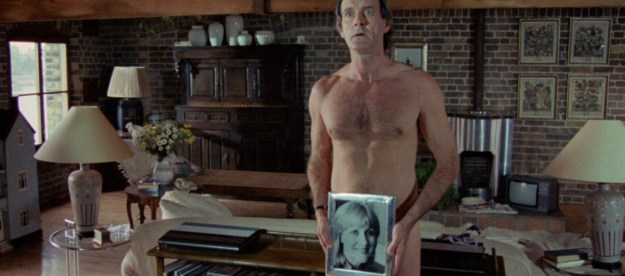 John Cleese, naked except for a photo held in front of his crotch, in A Fish Called Wanda.