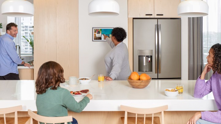 Amazon Echo Show 15 hanging horizontally on a kitchen wall.