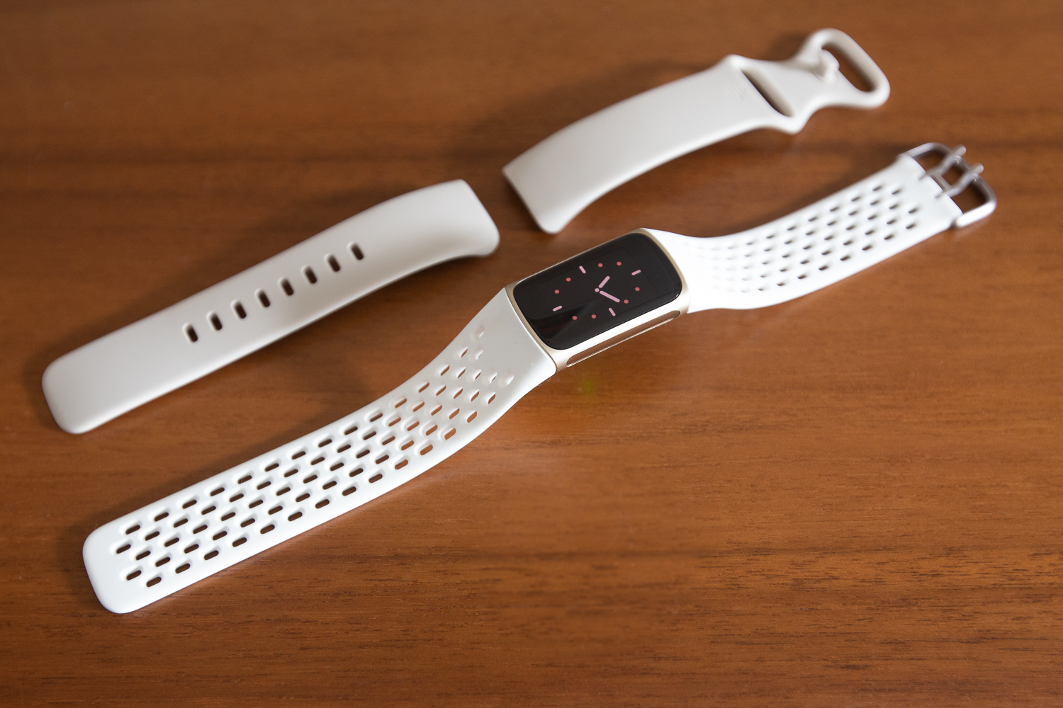 Fitbit Charge 5 standard and sport bands in white.