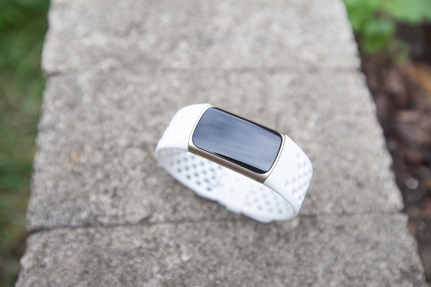 Top-down view of a Fitbit Charge 5 with a black screen.
