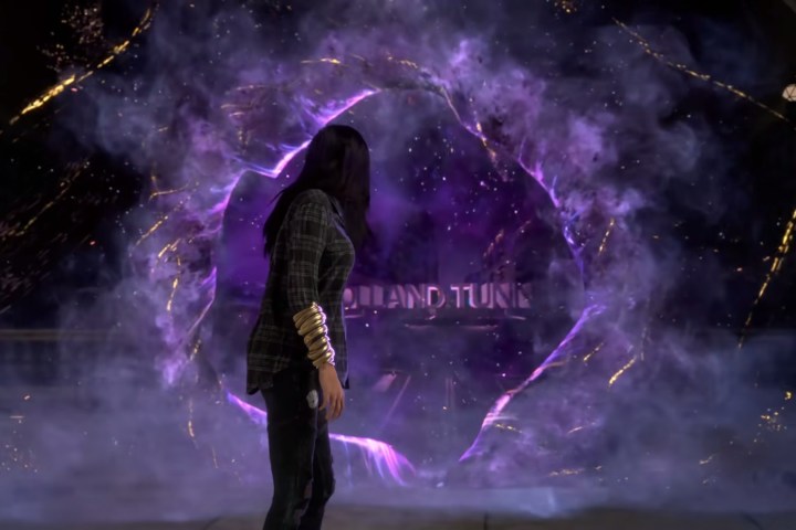The protagonist of Forspoken looks through a purple portal.