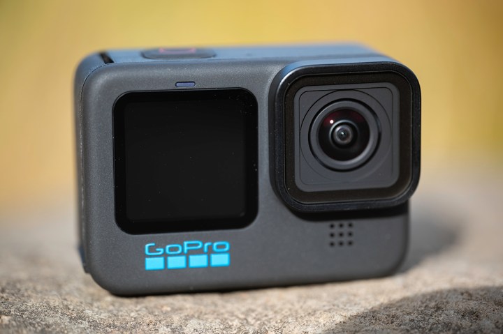 The front view of the GoPro Hero 10, which is placed on a rock.