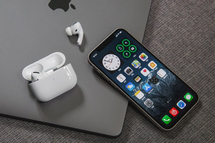 iPhone 12 with AirPods on MacBook.