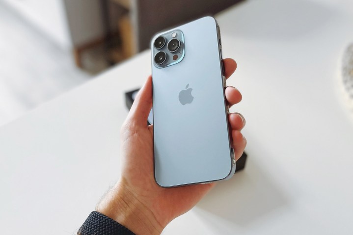 Man holding the Sierra Blue iPhone 13 Pro Max.