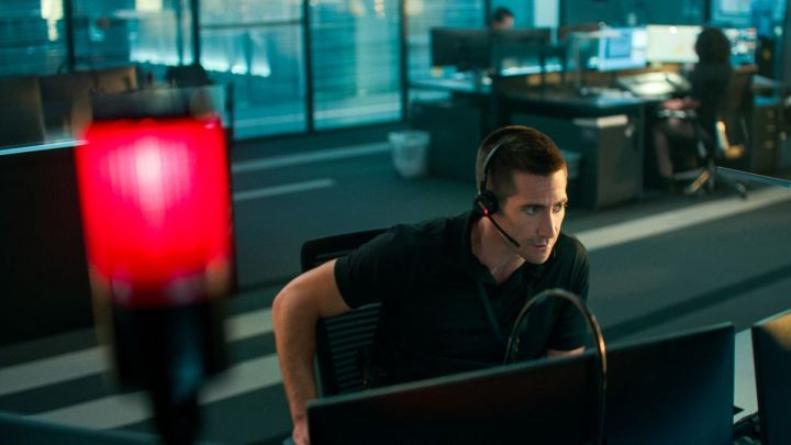 Jake Gyllenhaal sits at a desk in The Guilty.