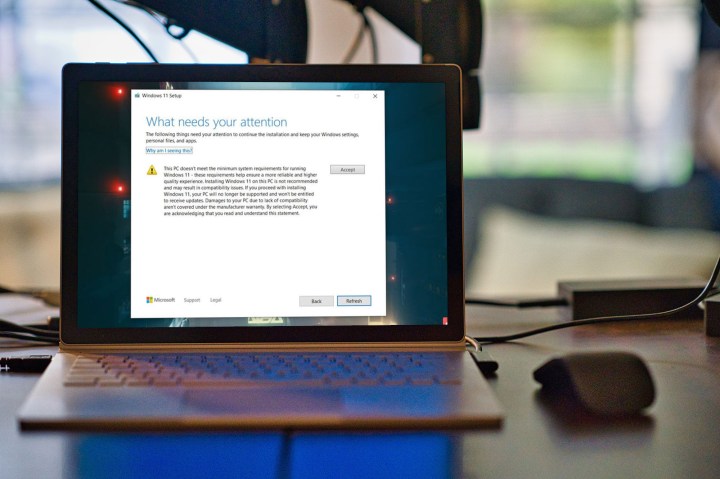 Unsupported Windows 11 waiver displayed on a laptop. 