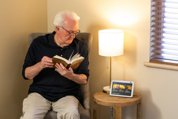 An older man using Alexa. 