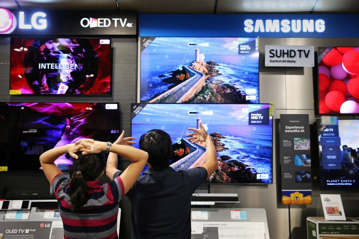 A couple discuss televisions while shopping at Best Buy in the CambridgeSide Galleria in Cambridge, MA on August 11, 2018. Massachusetts shoppers are taking advantage of the tax-free weekend after two years without.