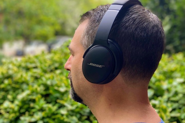 Man wearing Bose QuietComfort 45 noise-canceling headphones.