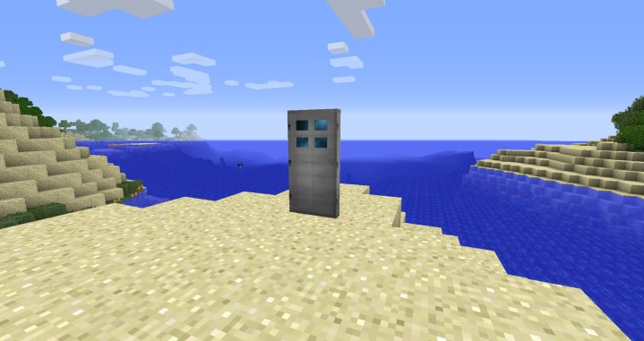 A dimensional door standing on the beach.