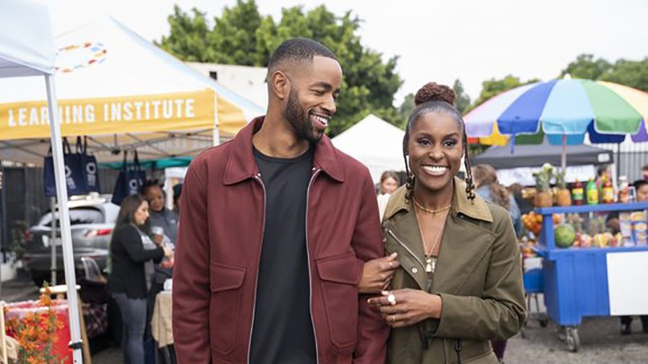 Issa Rae walking with a man in a scene from season 5 of Insecure.