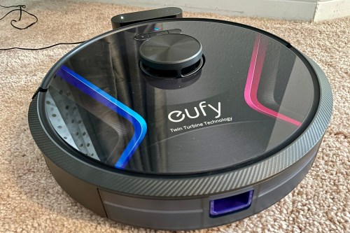 The RoboVac X8 docked on its charger.