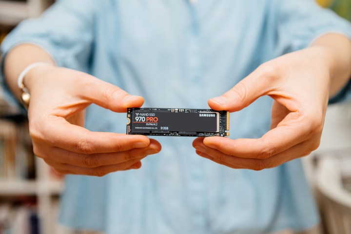 A woman holding the Samsung 870 Pro NVMe PCIe SSD in her hands.