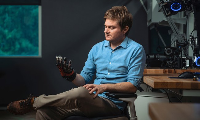 Meta researcher holding prototype haptic glove.