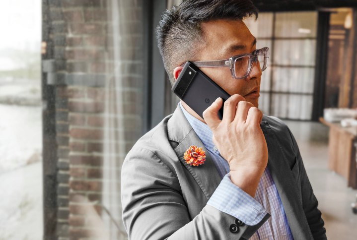 A man holding a Google Pixel 6 to his ear.