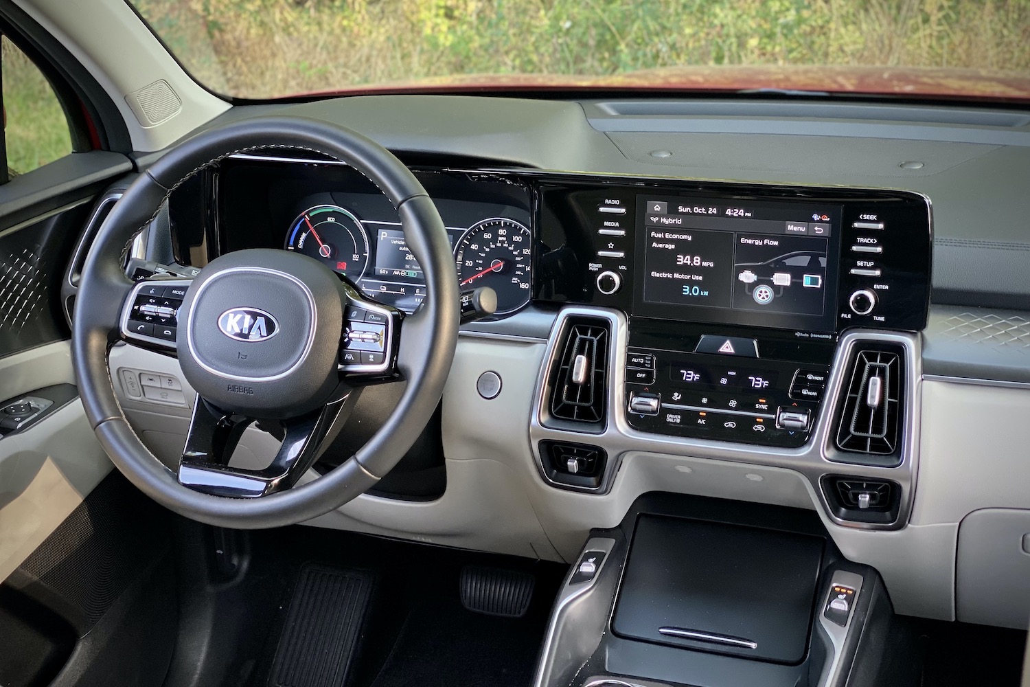 Dashboard of the 2021 Kia Sorento Hybrid with trees in the background.