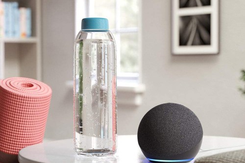 Amazon Echo Dot (4th Gen, 2020 release)on a table with a yoga matt and water bottle.
