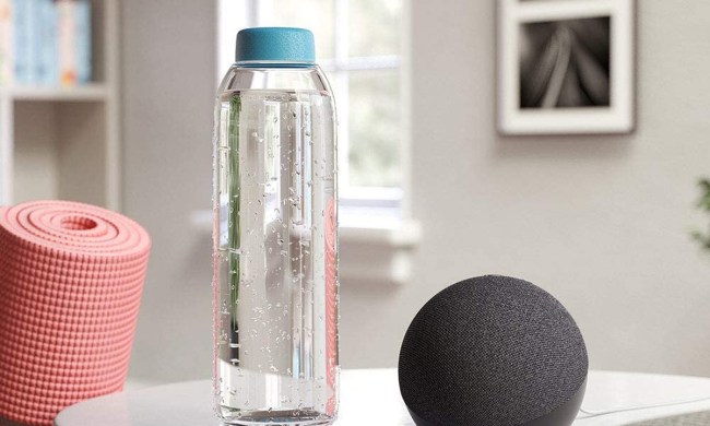 Amazon Echo Dot (4th Gen, 2020 release)on a table with a yoga matt and water bottle.