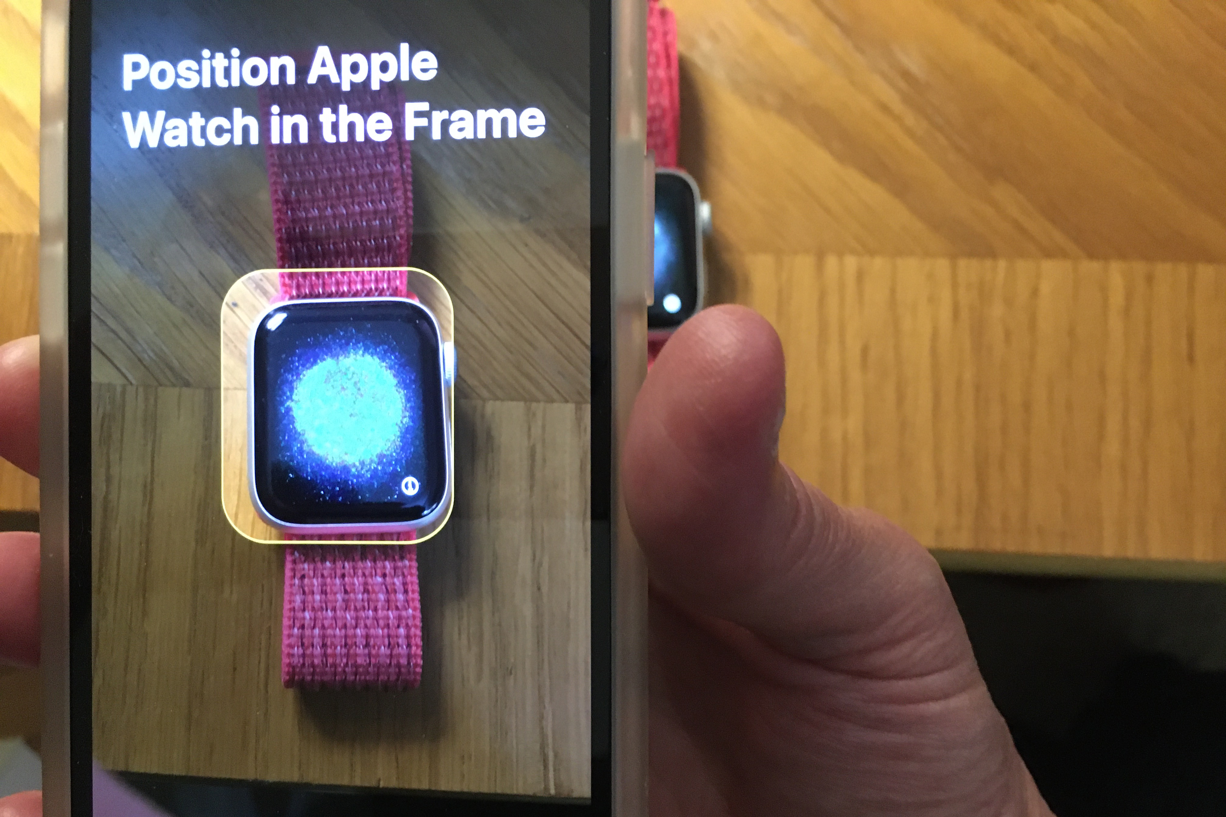 apple watch pair hold in frame.