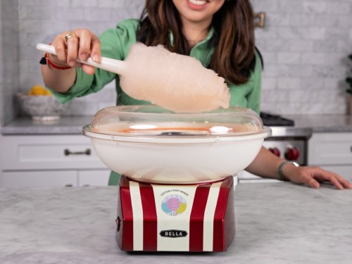 Bella Cotton Candy Maker with woman using cone to serve.