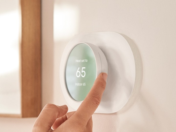 Adjusting the temperature on the Google Nest Thermostat.