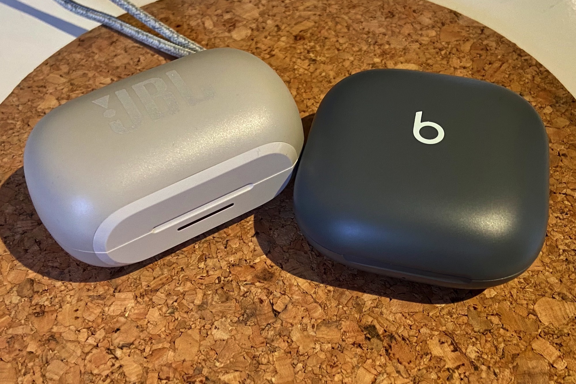JBL Reflect Flow Pro charging case seen next to Beats Fit Pro case.