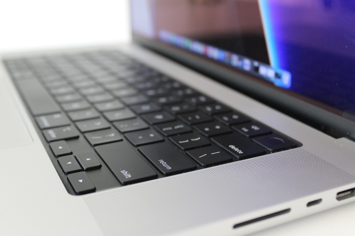 Vista lateral do Apple MacBook Pro mostrando o teclado e as portas.