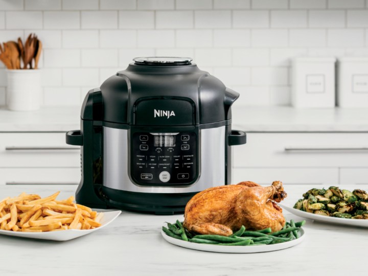 Ninja - Foodi 11-in-1 6.5-qt Pro Pressure Cooker + Air Fryer with Stainless finish, FD30, on counter with cooked chicken.
