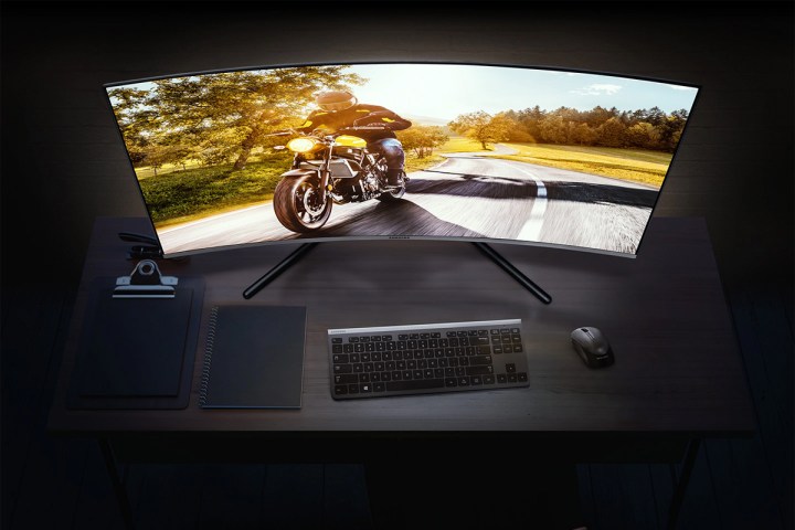 Samsung 32-inch curved 4K monitor on a desk.
