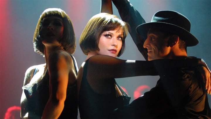Catherine Zeta-Jones dancing alongside two dancers.