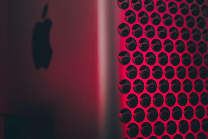 A close-up of a Mac Pro lit in red. 
