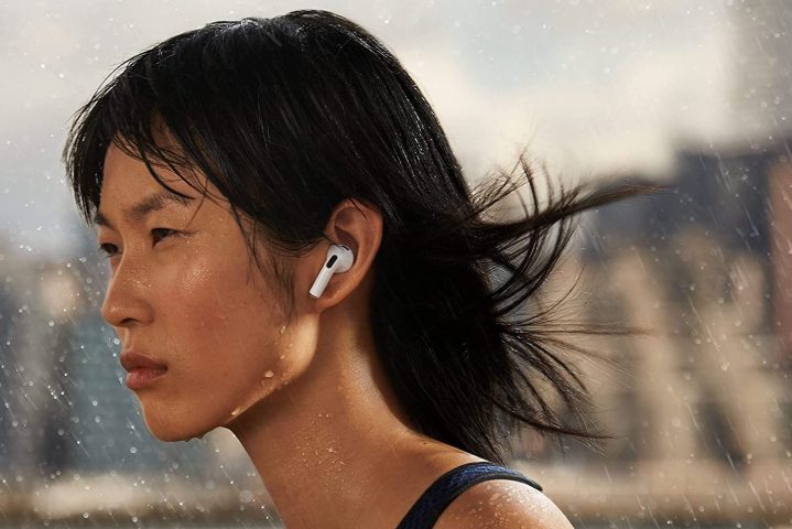 Model wearing new Apple AirPods 3rd generation.