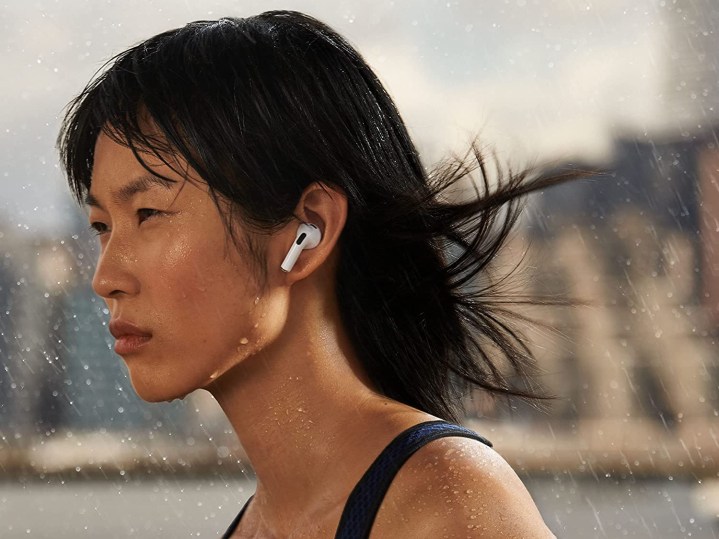 Model wearing new Apple AirPods 3rd generation.