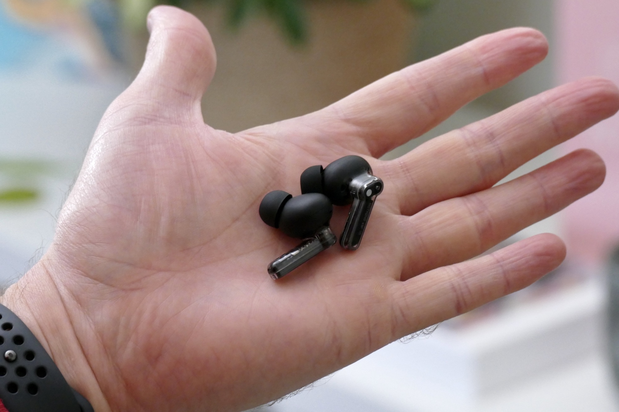 Nothing Ear 1 Black Edition earbuds in hand.