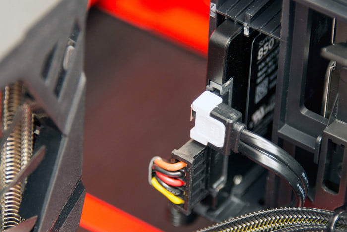 Plugging a SATA cable into a hard drive.